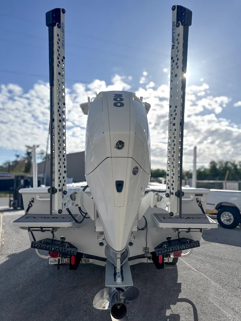 Slide: The Image of 2021 Dorado 25 FD boat with dual power poles and outboard motor, under a bright sky. - 5