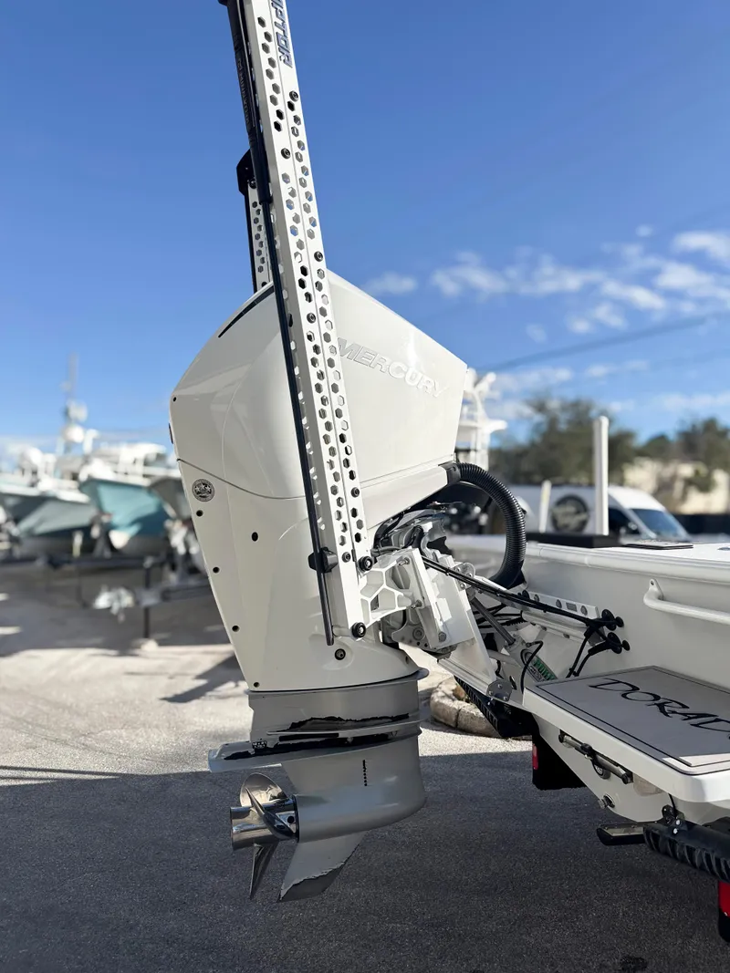 Slide: The Image of 2021 Dorado 25 FD boat with outboard motor, docked under clear blue sky. - 6