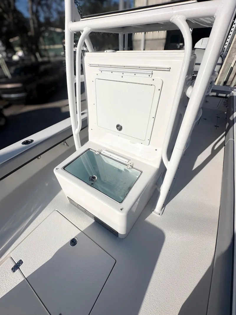 Slide: The Image of 2021 Dorado 25 FD boat with open storage compartment and sleek white design. - 9