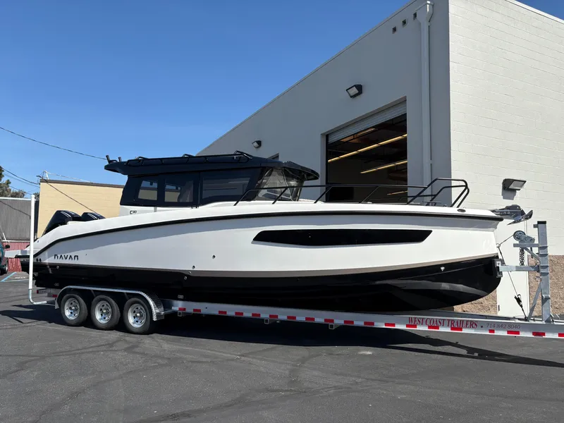 Slide: The Image of 2025 Navan C30 boat on a trailer outside a building. - 1
