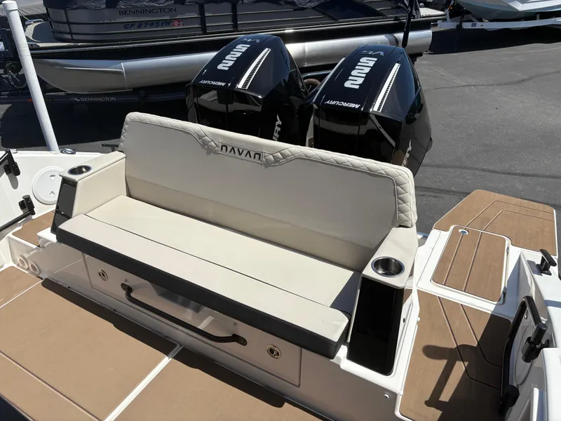 Slide: The Image of 2025 Navan C30 boat with dual outboard motors and cushioned seating. - 11