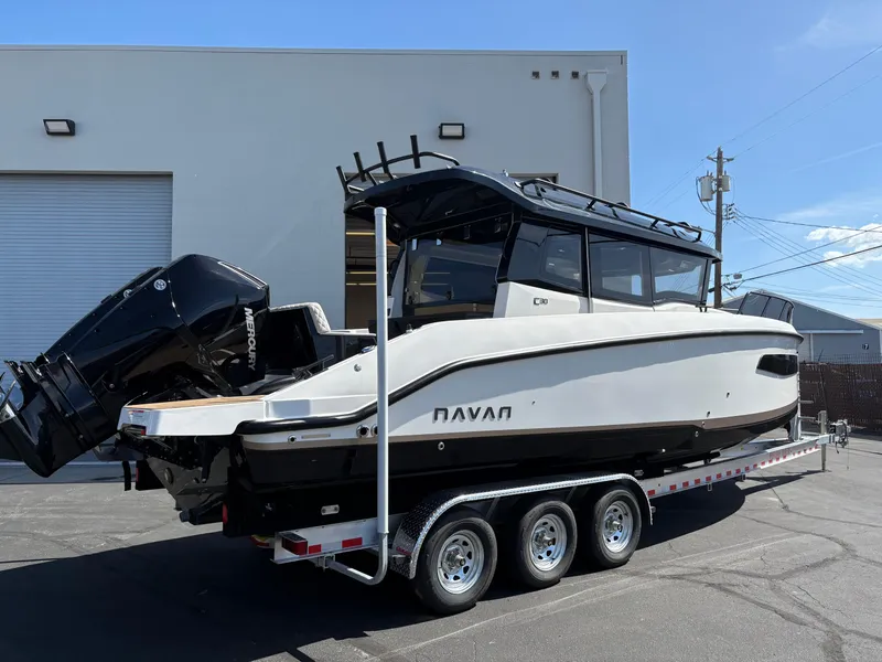 Slide: The Image of 2025 Navan C30 boat on a trailer, parked outdoors near a building. - 4