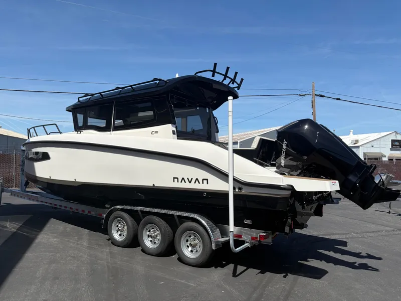 Slide: The Image of Navan C30 2025 boat on a trailer, parked outdoors under clear blue sky. - 6