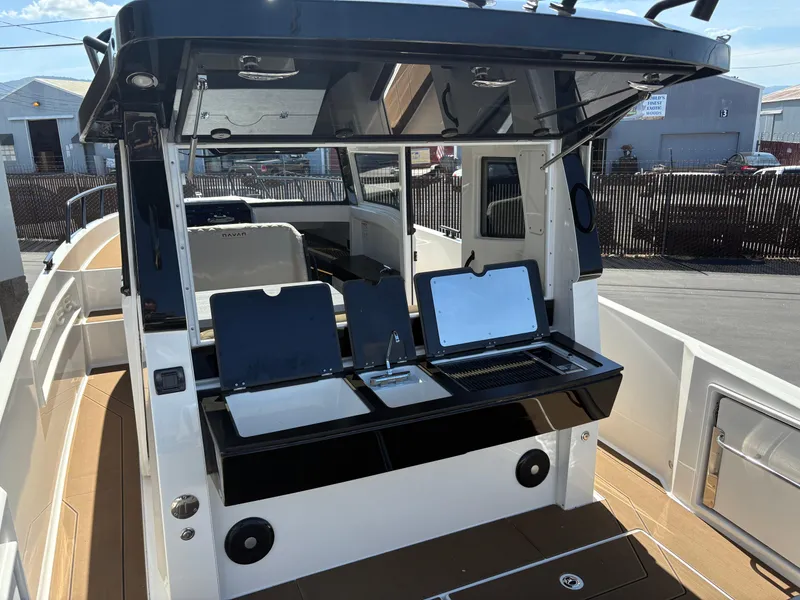 Slide: The Image of 2025 Navan C30 boat with open compartments, docked outdoors. - 9