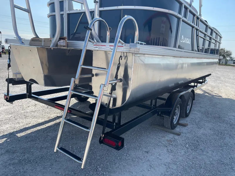 Slide: The Image of 2025 Landau Island Breeze 25 pontoon boat with 225HP Suzuki engine on trailer. - 18