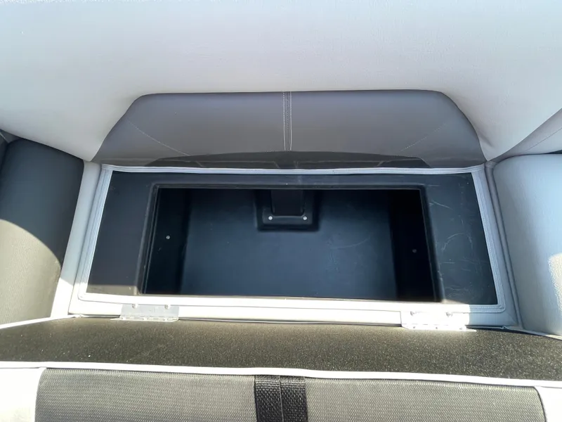Slide: The Image of Open storage compartment on 2025 Landau Island Breeze 25 boat seat. - 8