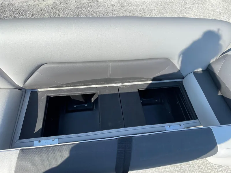 Slide: The Image of 2025 Landau Island Breeze 25 boat seat storage compartment, open and empty. - 9