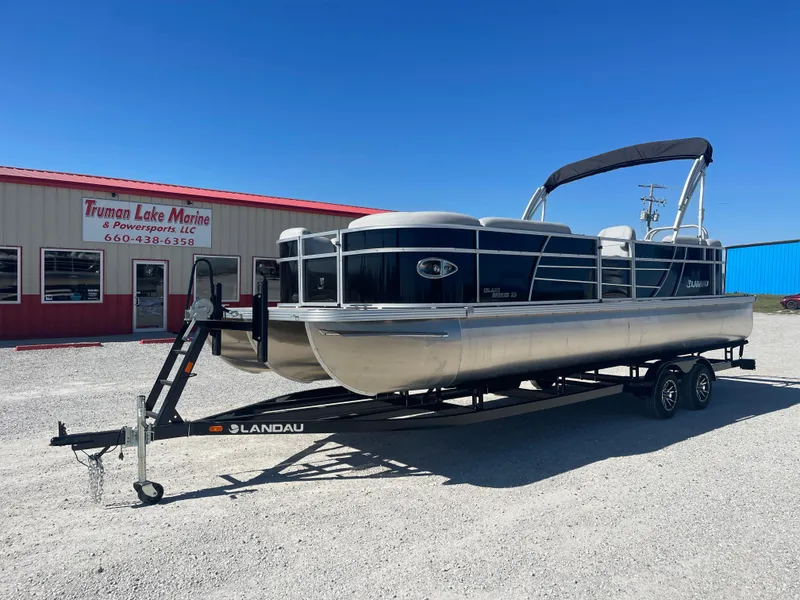 Slide: The Image of 2025 Landau Island Breeze 25 pontoon boat with 225HP Suzuki engine on trailer. - 3