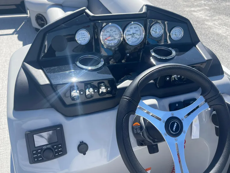 Slide: The Image of 2025 Landau Island Breeze 25 dashboard with gauges and steering wheel, powered by 225HP Suzuki engine. - 9