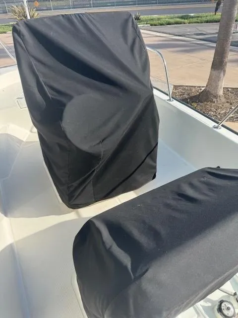 Slide: The Image of 2017 Boston Whaler 150 Montauk boat with black seat covers. - 1