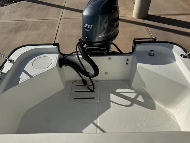 Slide: The Image of 2017 Boston Whaler 150 Montauk boat with 70 HP outboard motor, rear view. - 2