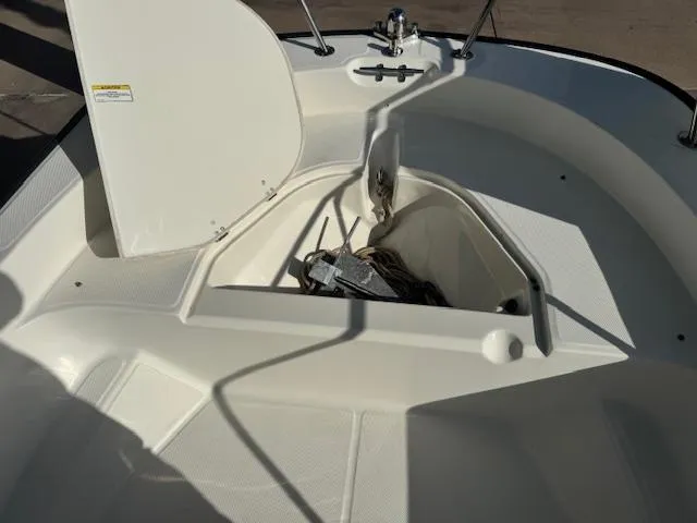 Slide: The Image of 2017 Boston Whaler 150 Montauk boat anchor storage compartment open. - 3