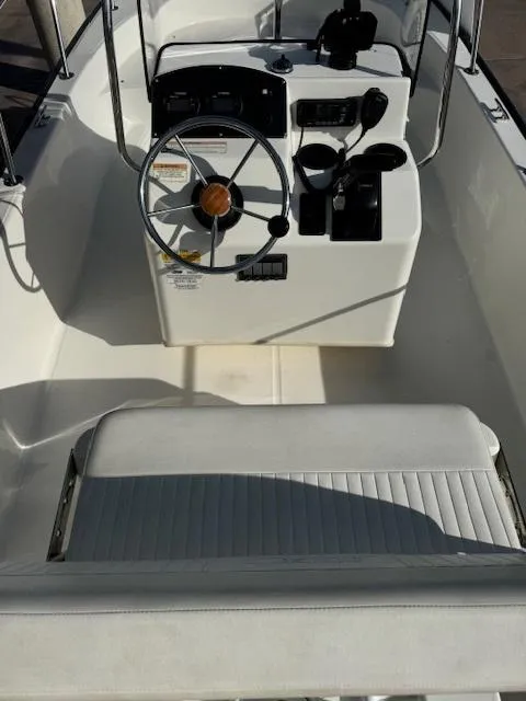 Slide: The Image of 2017 Boston Whaler 150 Montauk boat interior with steering console and seating. - 4