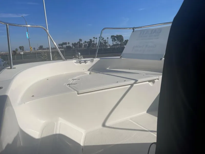 Slide: The Image of 2017 Boston Whaler 150 Montauk boat interior with clear sky background. - 7