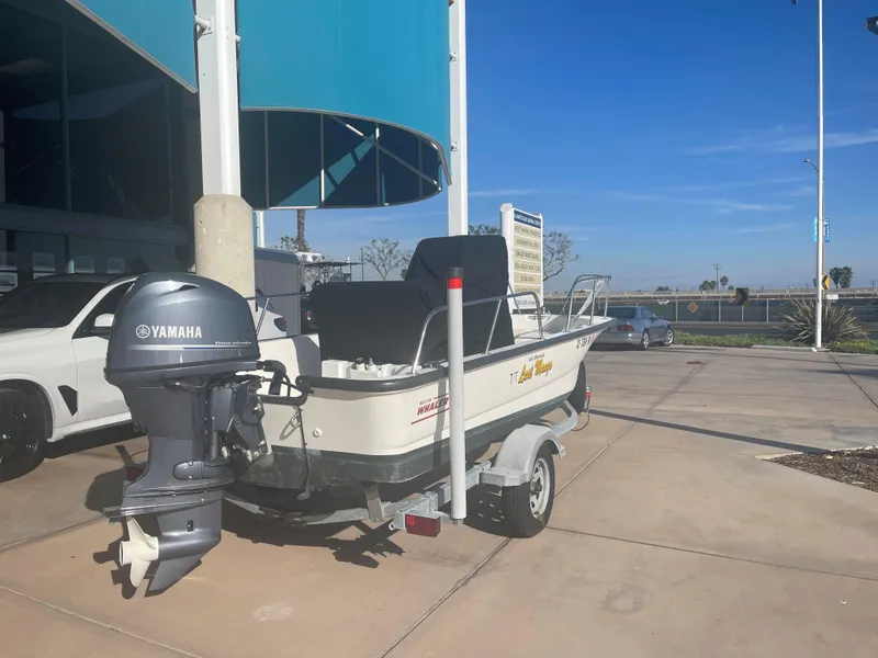 Slide: The Image of 2017 Boston Whaler 150 Montauk boat with Yamaha engine on a trailer. - 8