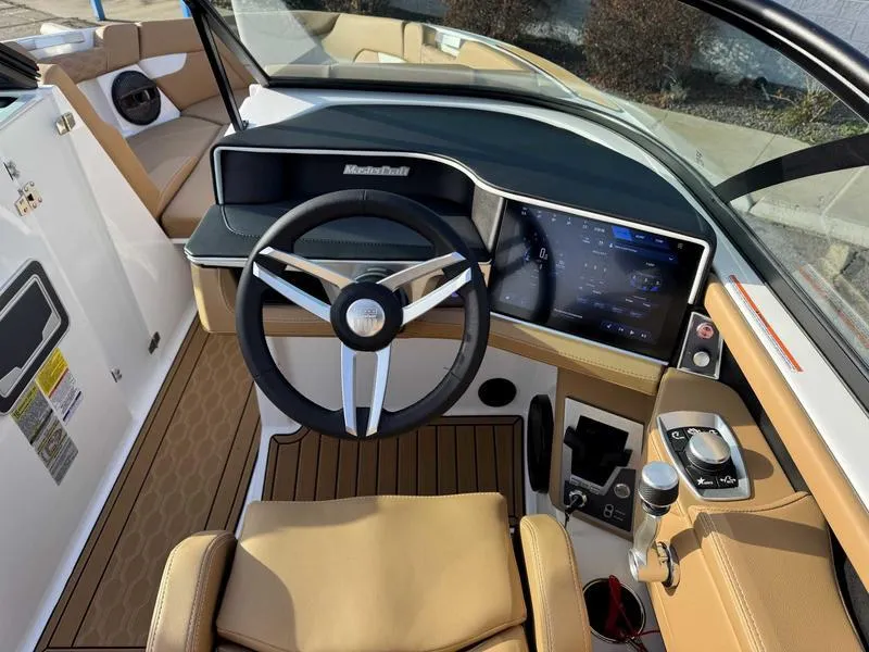 Slide: The Image of 2025 MasterCraft XT23 boat interior with modern dashboard and steering wheel. - 12