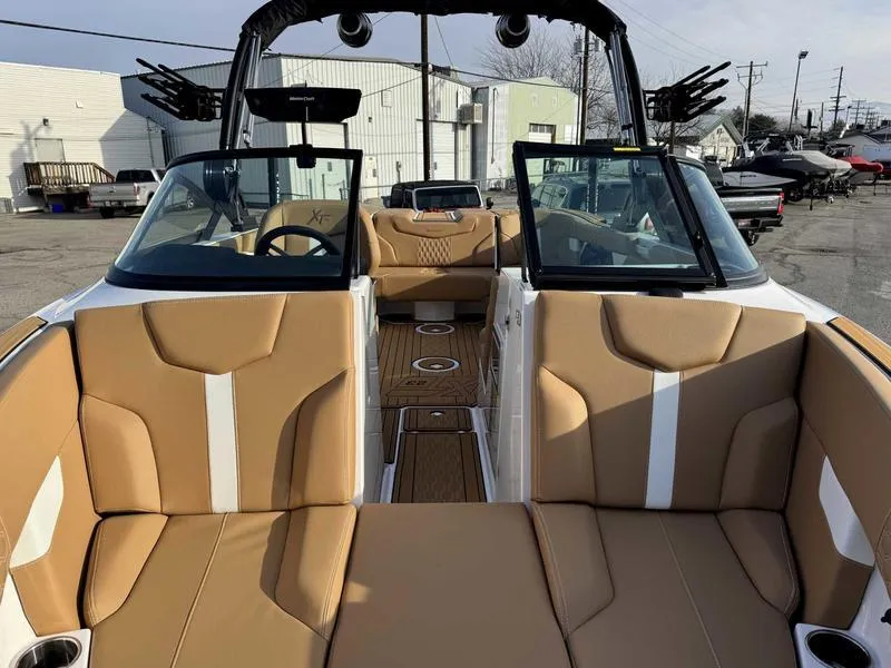 Slide: The Image of 2025 MasterCraft XT23 boat interior with tan seating and modern design. - 14