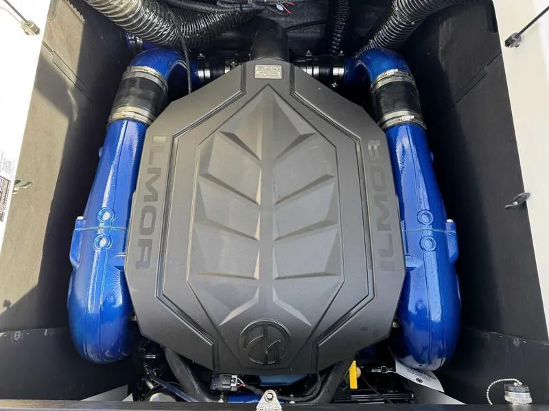 Slide: The Image of 2025 MasterCraft XT23 Ilmor engine with blue accents in boat compartment. - 15