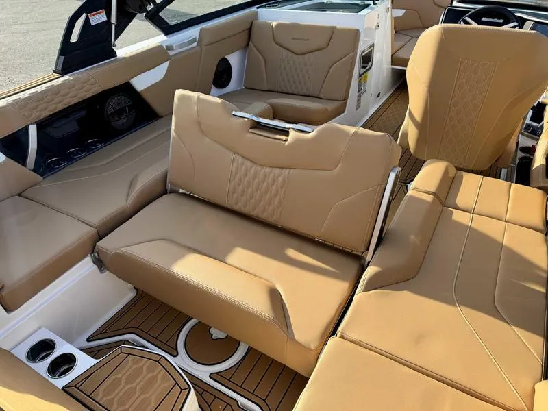 Slide: The Image of 2025 MasterCraft XT23 boat interior with tan leather seating and modern design. - 16