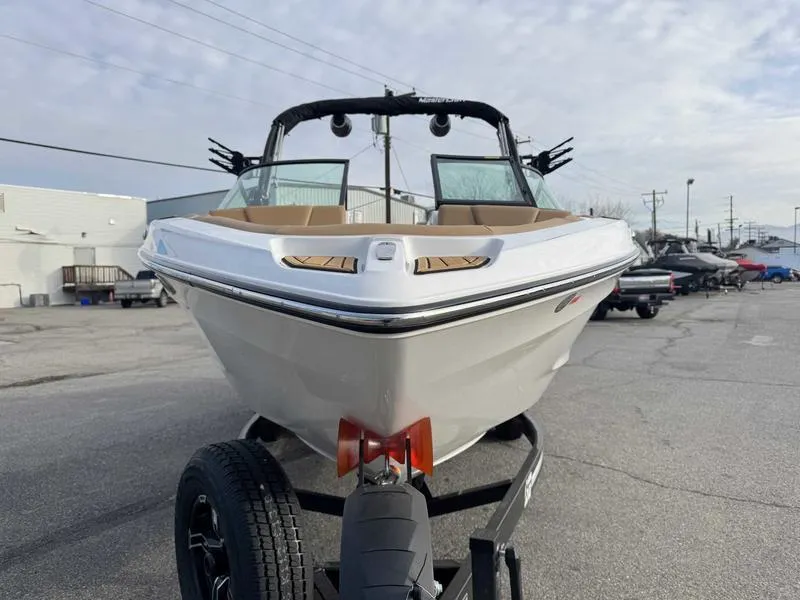 Slide: The Image of 2025 MasterCraft XT23 boat on trailer, parked outdoors. - 4