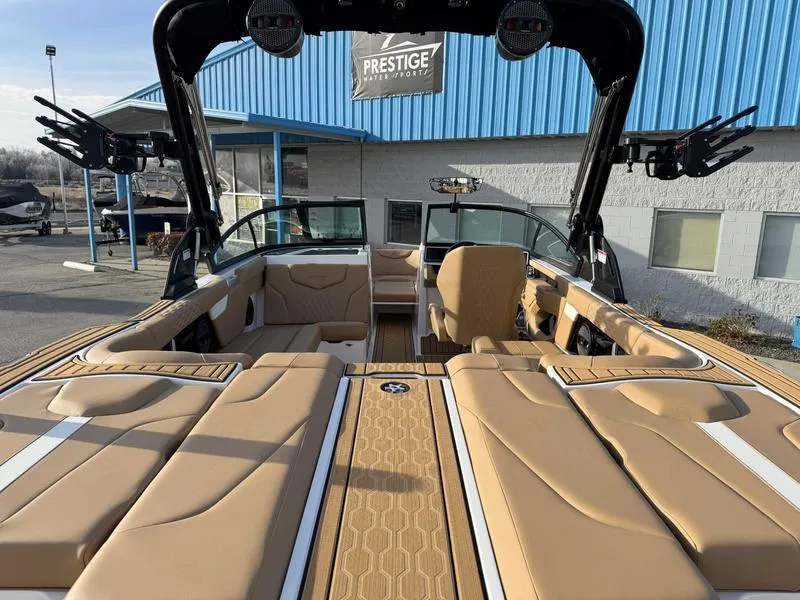 Slide: The Image of 2025 MasterCraft XT23 boat interior with tan seating and modern design. - 8