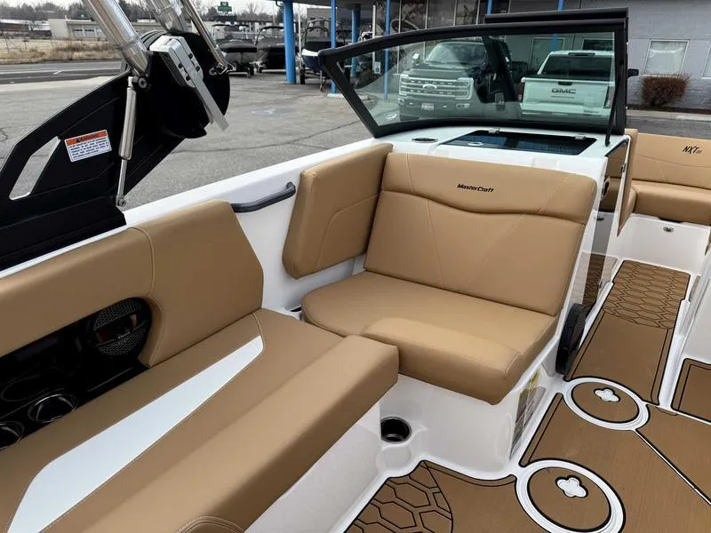 Slide: The Image of 2025 MasterCraft NXT20 boat interior with tan seating and modern design. - 10