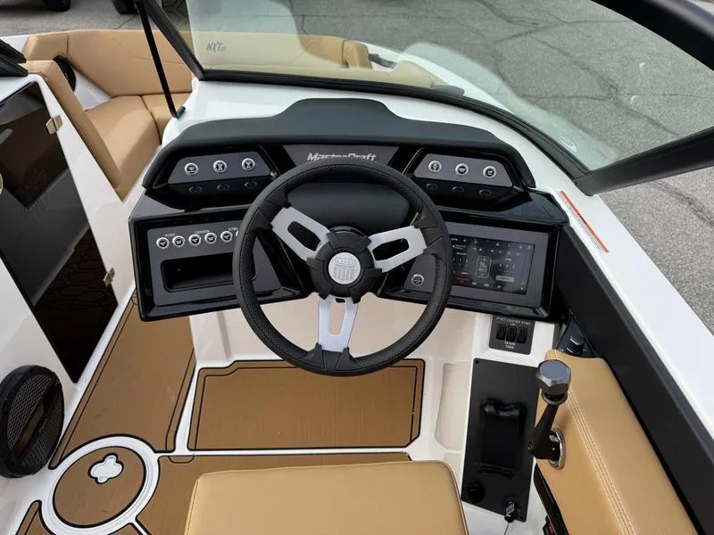 Slide: The Image of 2025 MasterCraft NXT20 boat interior with modern dashboard and steering wheel. - 12