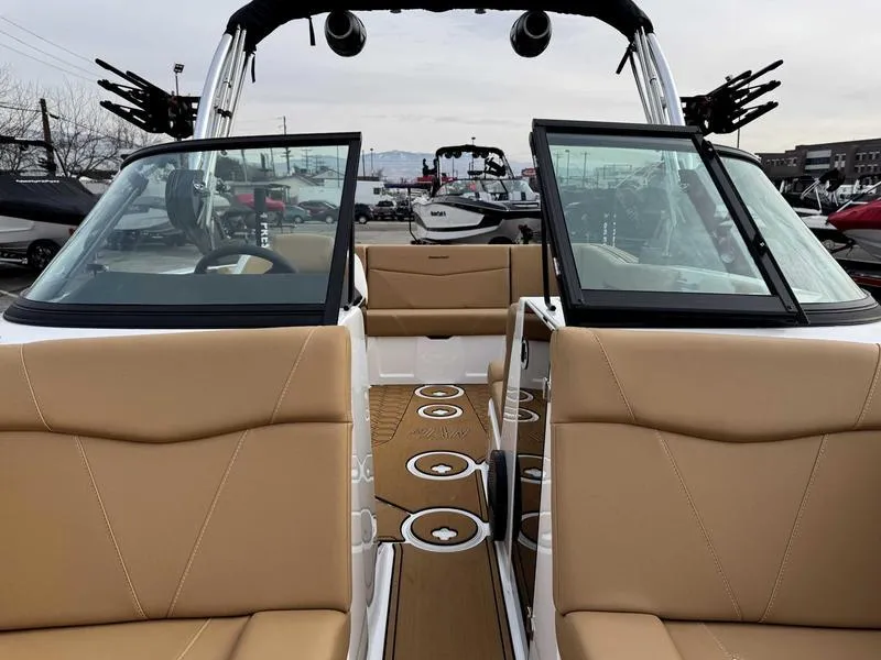 Slide: The Image of 2025 MasterCraft NXT20 boat interior with tan seats and open deck layout. - 13
