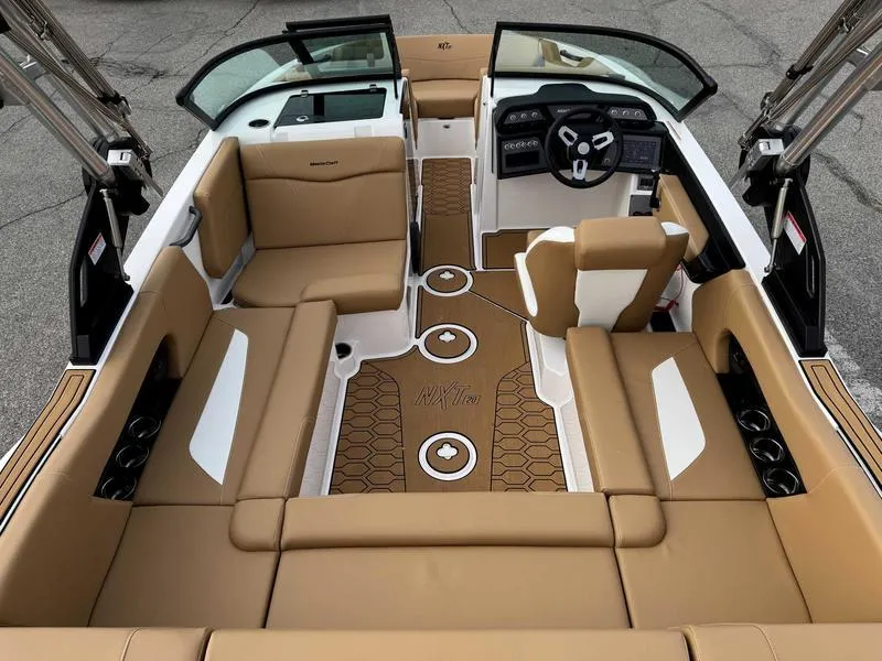 Slide: The Image of 2025 MasterCraft NXT20 boat interior with tan seating and modern dashboard. - 9