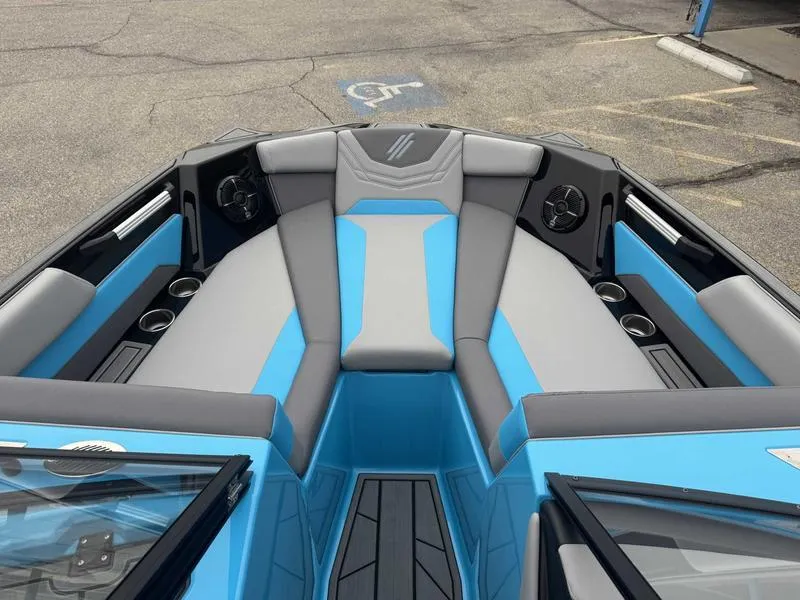Slide: The Image of 2025 ATX Surf Boats 22 Type-S interior with blue and gray seating, cup holders, and speakers. - 13