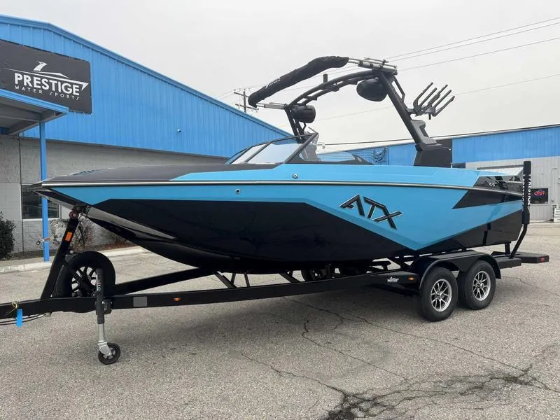 Slide: The Image of 2025 ATX Surf Boats 22 Type-S in blue and black on a trailer. - 2