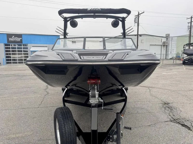 Slide: The Image of 2025 ATX Surf Boats 22 Type-S on trailer in industrial setting. - 4