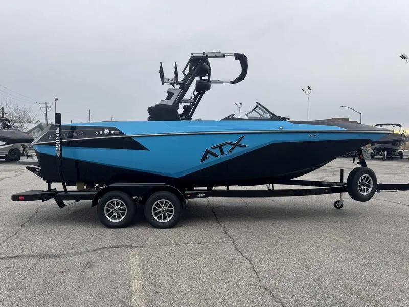 Slide: The Image of 2025 ATX Surf Boats 22 Type-S in blue on trailer, parked in lot. - 5