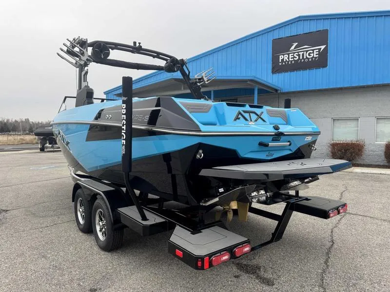 Slide: The Image of 2025 ATX Surf Boats 22 Type-S in blue, parked at Prestige Water Sports. - 6