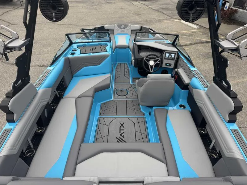 Slide: The Image of 2025 ATX Surf Boats 22 Type-S interior with blue and gray seating, modern dashboard, and speakers. - 8
