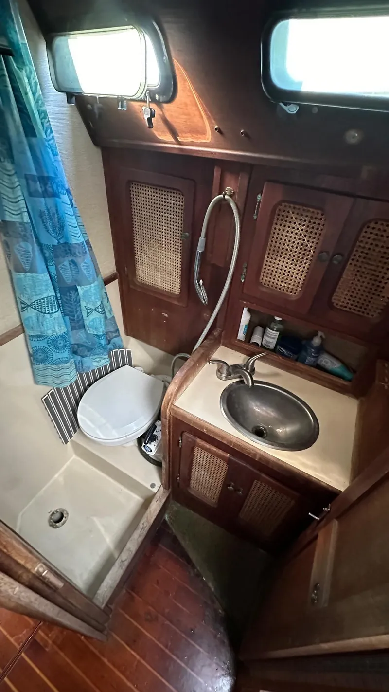 Slide: The Image of 1985 S2 11.0A yacht bathroom with sink, toilet, and shower. - 10