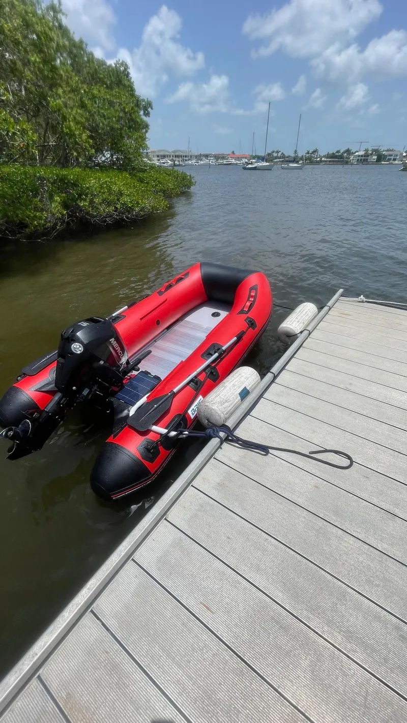 Slide: The Image of Red inflatable boat docked on a sunny day, S2 11.0A model, 1985. - 11