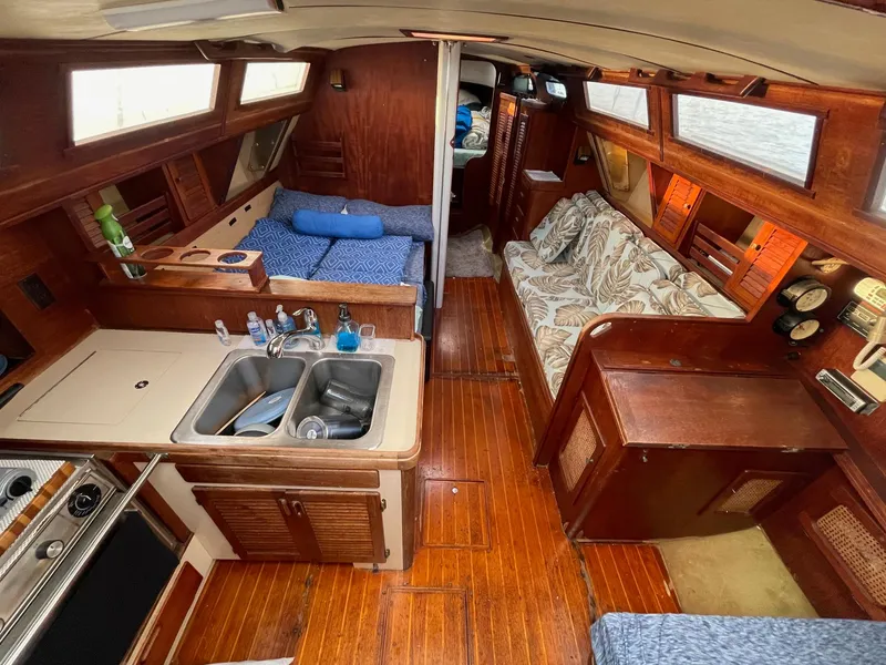 Slide: The Image of Interior of 1985 S2 11.0A sailboat with wood finish and cozy seating. - 13