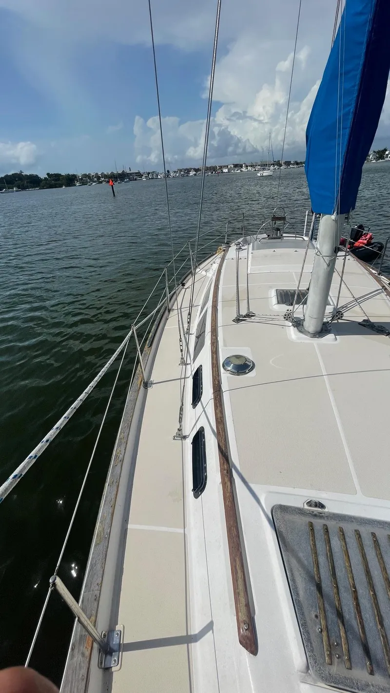 Slide: The Image of Sailboat on calm water, S2 11.0A model, 1985, with blue sail and clear sky. - 5