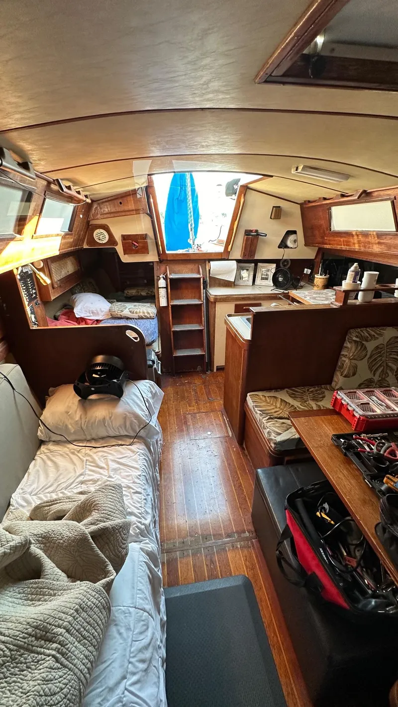 Slide: The Image of Interior of a 1985 S2 11.0A sailboat with cozy living space and wooden furnishings. - 9