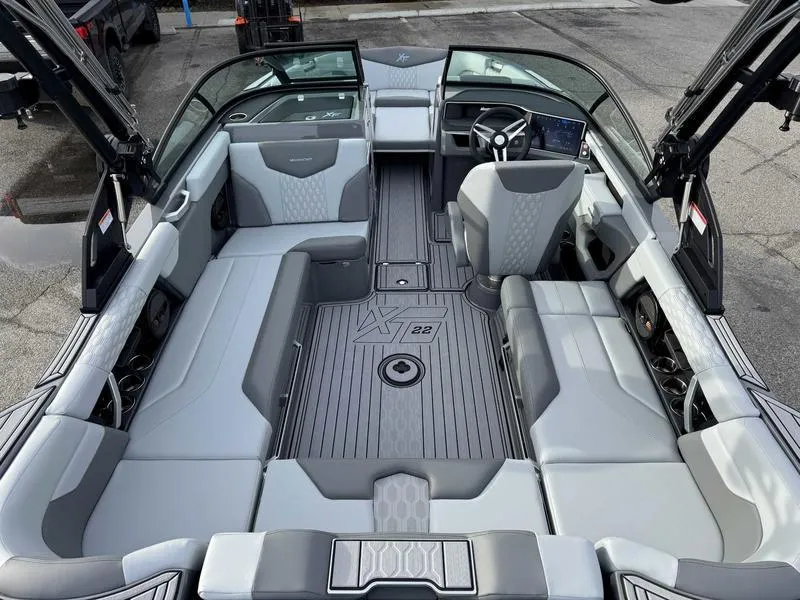 Slide: The Image of 2025 MasterCraft XT22 boat interior with sleek gray seating and modern dashboard. - 9
