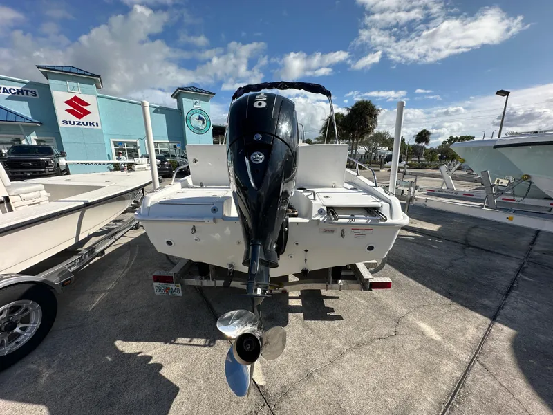 Slide: The Image of 2019 Boston Whaler 180 Dauntless boat with outboard motor in a marina. - 3