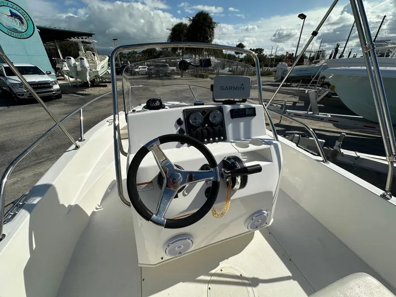 Slide: The Image of 2019 Boston Whaler 180 Dauntless boat cockpit with steering wheel and Garmin navigation system. - 4