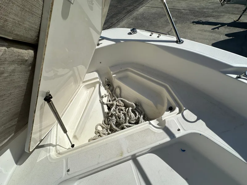 Slide: The Image of 2019 Boston Whaler 180 Dauntless boat with open storage compartment and rope. - 6