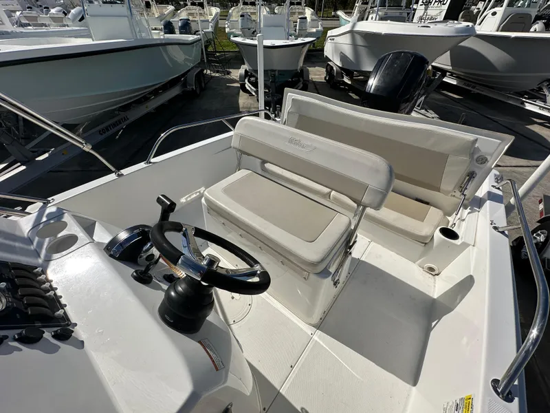 Slide: The Image of 2019 Boston Whaler 180 Dauntless boat interior with steering wheel and seating. - 9