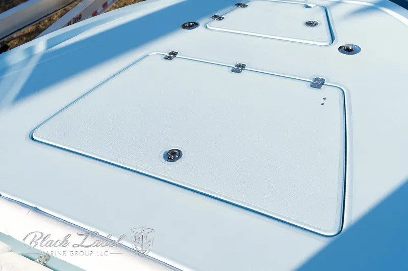 Slide: The Image of 2025 Caymas 28 HB boat deck with storage compartments, featuring sleek design and secure latches. - 10