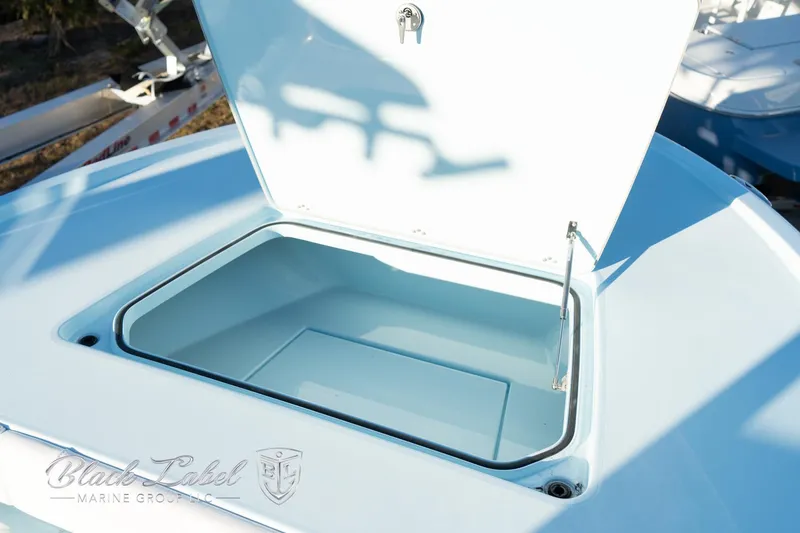 Slide: The Image of 2025 Caymas 28 HB boat storage compartment open on deck. - 11