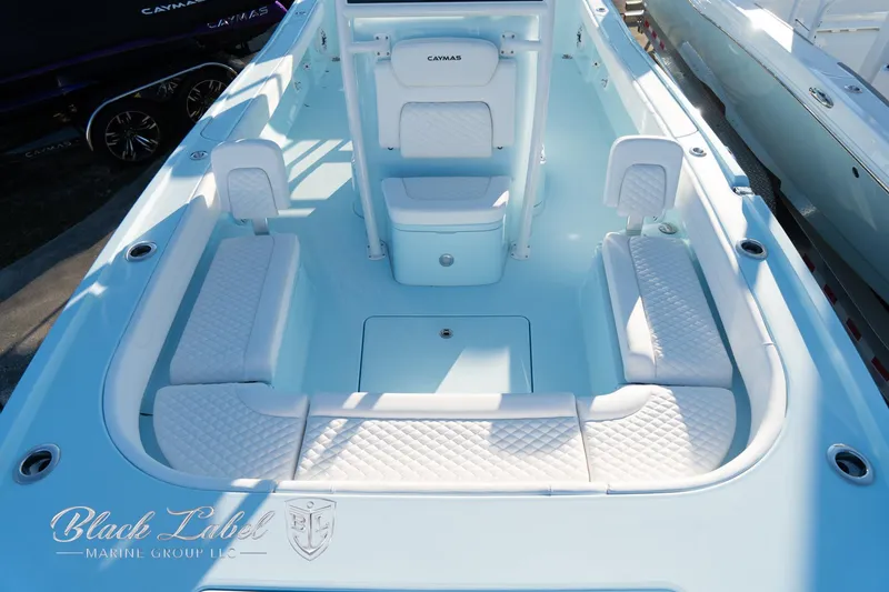 Slide: The Image of 2025 Caymas 28 HB boat interior with cushioned seating and sleek design. - 12