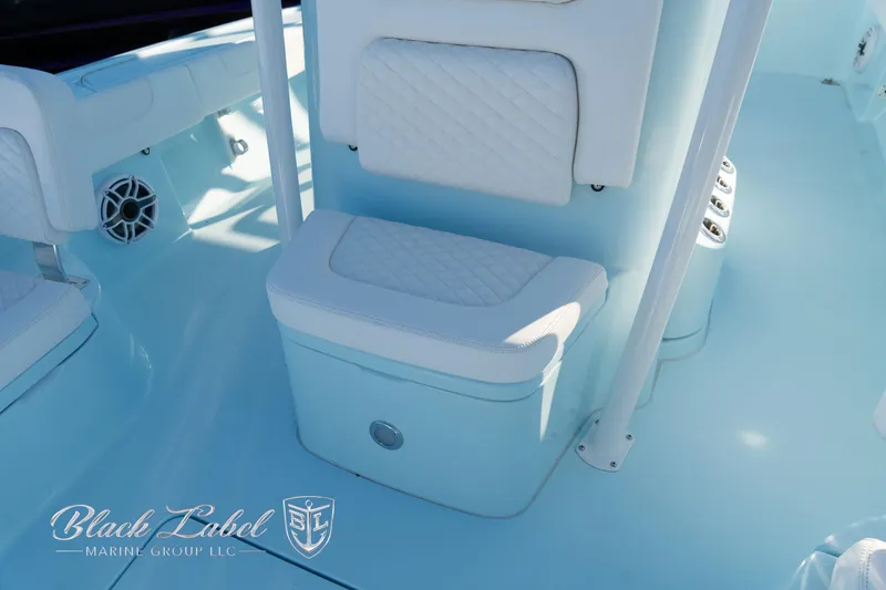 Slide: The Image of 2025 Caymas 28 HB boat interior with cushioned seating and marine speaker. - 13