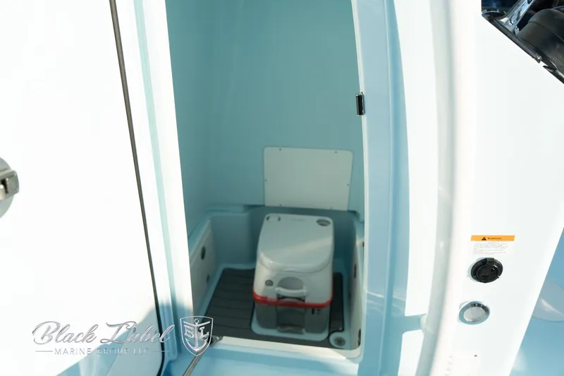 Slide: The Image of 2025 Caymas 28 HB boat interior with compact marine toilet. - 16